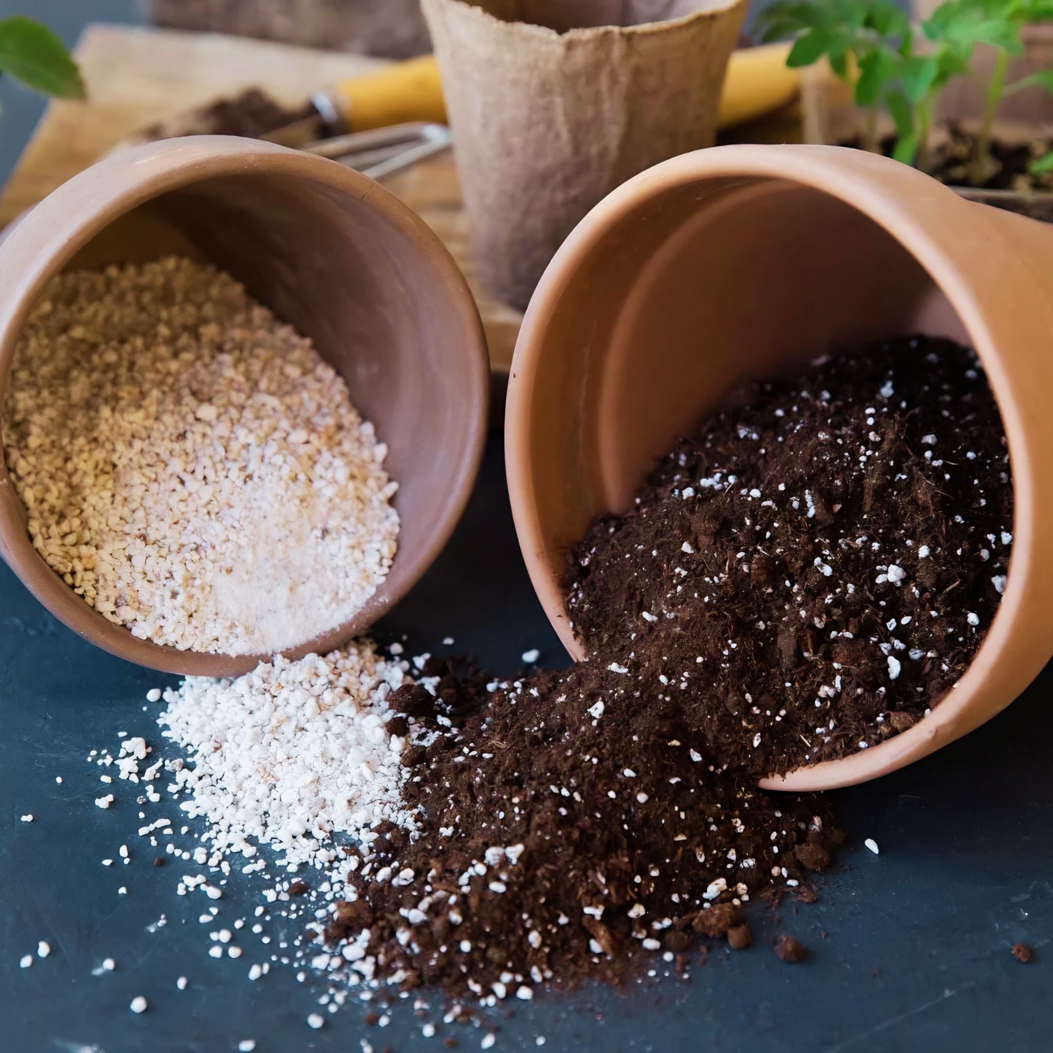 Two tipped-over terracotta pots spill out contents: one with white perlite and the other with dark potting soil mixed with perlite. Gardening tools and a plant are visible in the background.