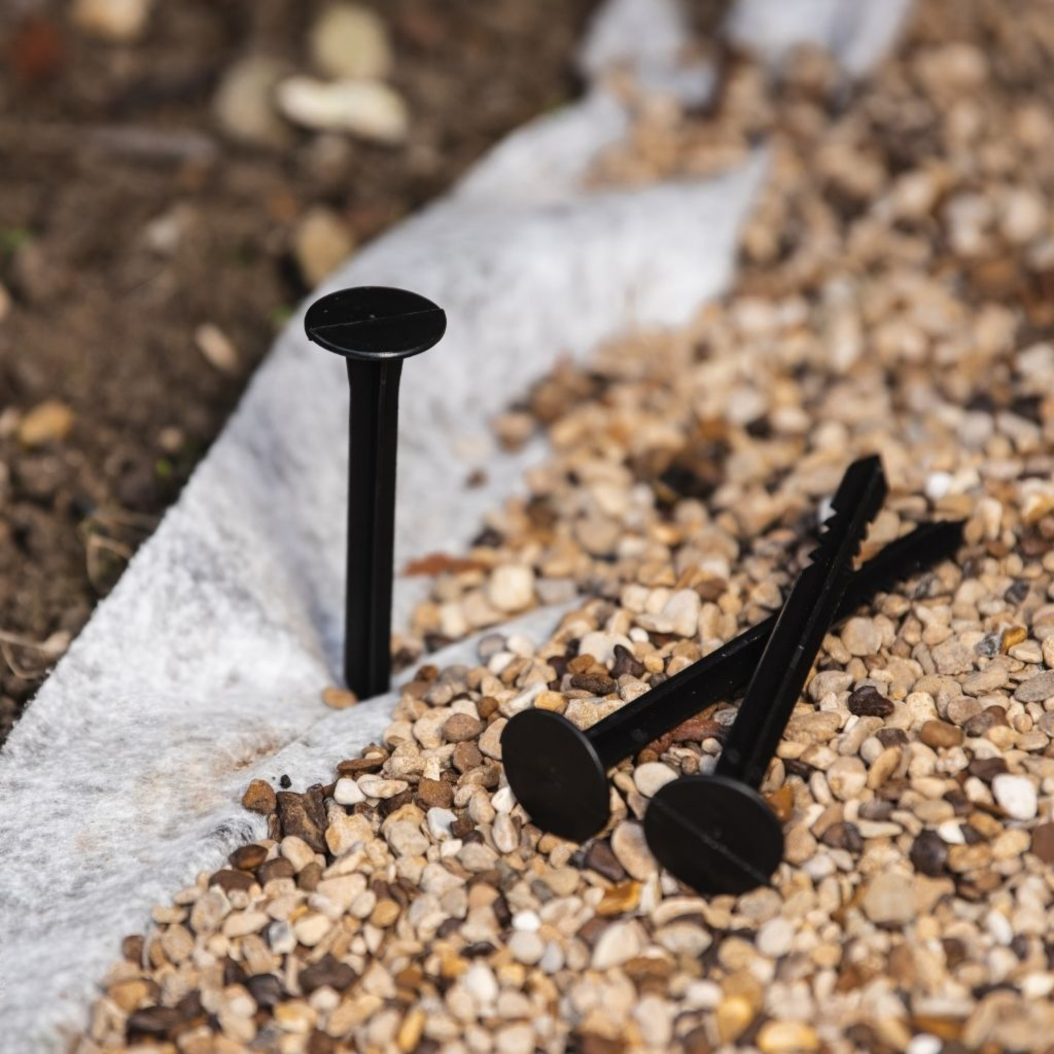 Garden fabric pegs pack for securing weed control membrane in soil or gravel beds.